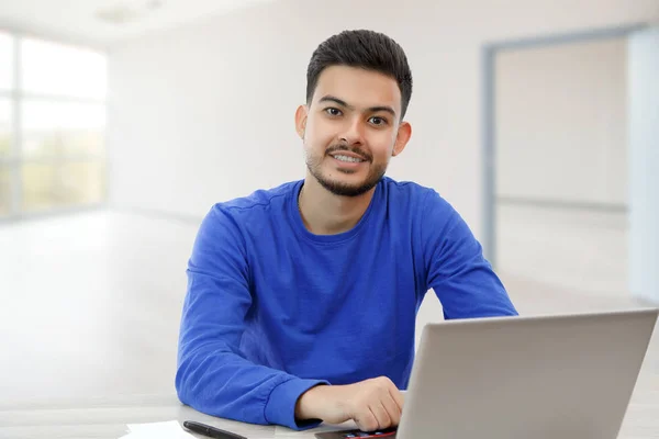 Un joven sentado en un ordenador portátil en busca de trabajo, haciendo negocios — Foto de Stock