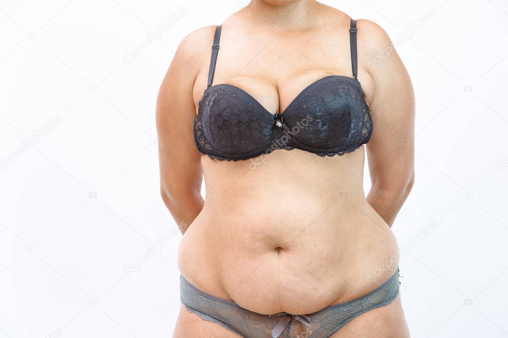 young overweighted woman in lingerie on white isolated backgroun