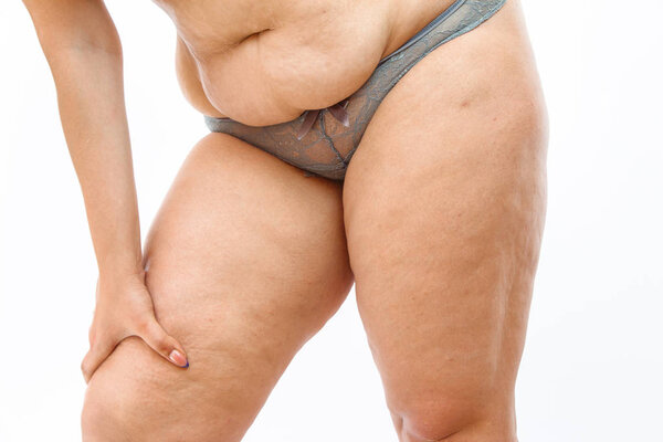 young overweighted woman in lingerie on white isolated backgroun