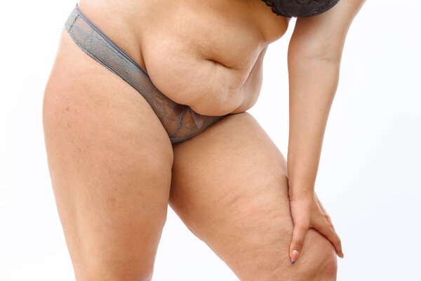 young overweighted woman in lingerie on white isolated backgroun
