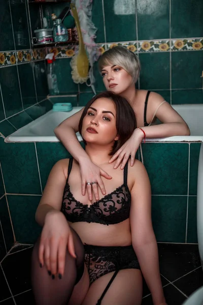 Blonde with brunette in bathroom in underwear touch each other a — Stock Photo, Image