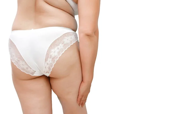 A woman with excess weight applying cream on the buttocks and le — Stock Photo, Image