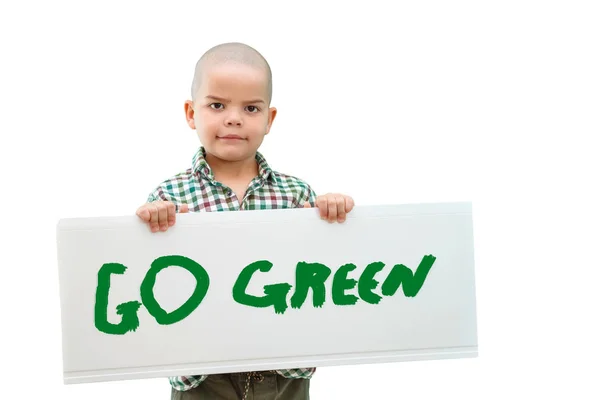 Rapaz segurando um sinal "ir verde" nas mãos. Em fundo claro . — Fotografia de Stock