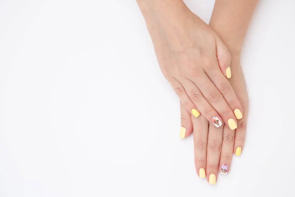 Women's hands with a beautiful manicure with drawings of cakes a — Stock Photo, Image