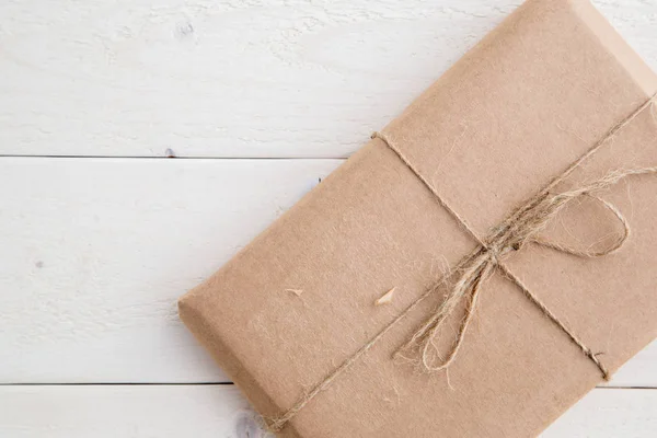 parcel,gift Packed in eco-friendly paper on light wooden backgro