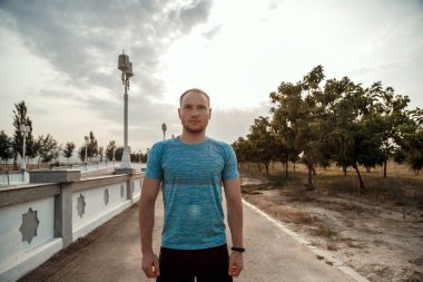 mavi bir t-shirt ve siyah şort kafkas adam portresi kim