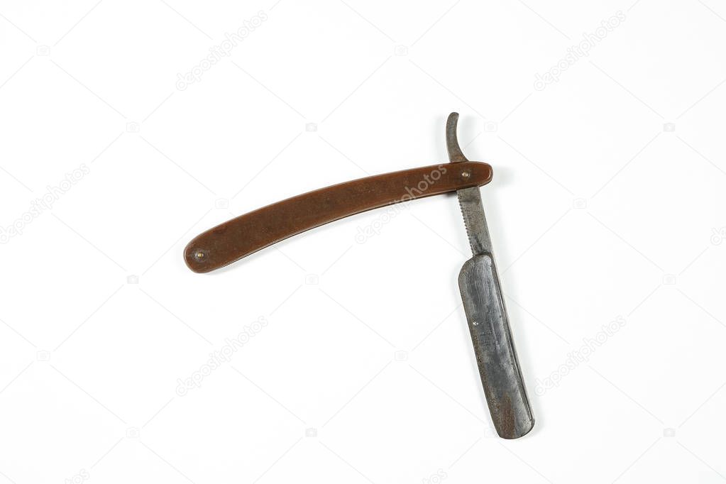 dangerous vintage shaving blade on white isolated background