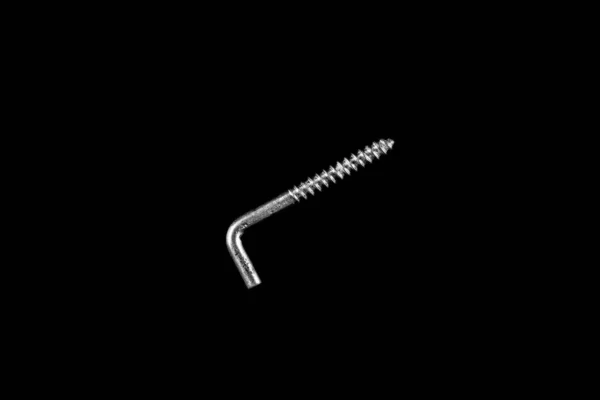 Metal self-tapping screw on black isolated background — Stock Photo, Image