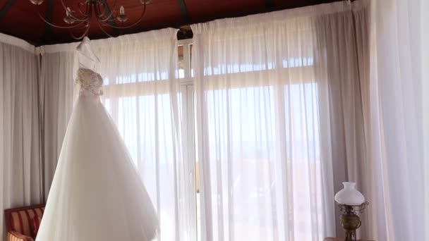 Wedding Dress Hanging Lamp Slow Panning Left — Stock Video