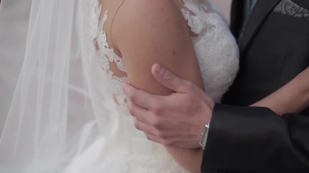 Groom caressing bride's arm. Close up. — Stock Video