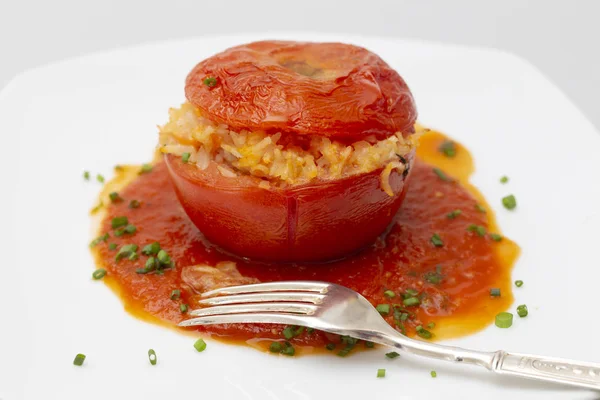 Stuffed tomato garnish and fork — Stock Photo, Image