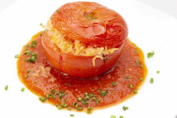 Stuffed tomato with sauce and chive garnish — Stock Photo, Image