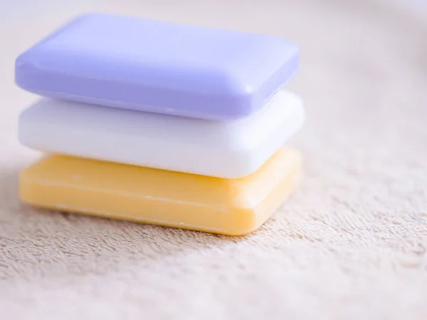 stock image three bars of soap on a brown towel