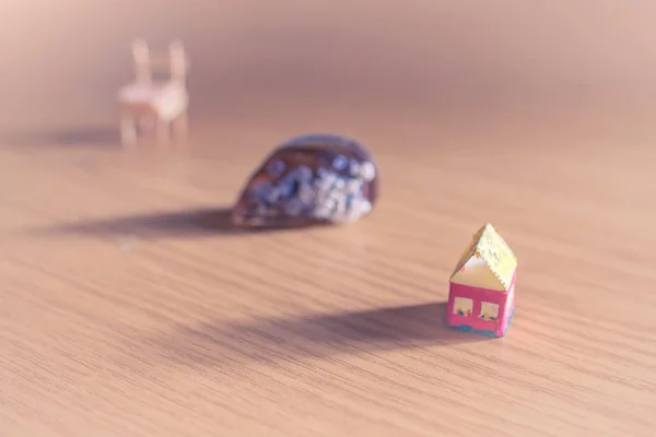 Summertime. Small toy house, seashell and chair.