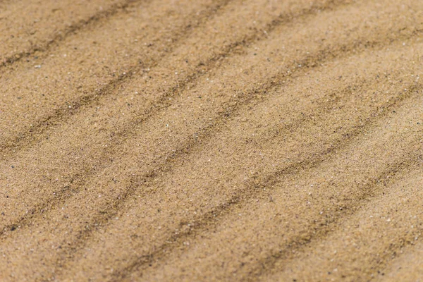 Diagonal vågor av sand. Sandy textur bakgrund. — Stockfoto