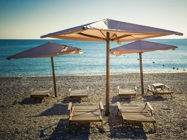 Sun umbrellas and beach beds — Stock Photo, Image