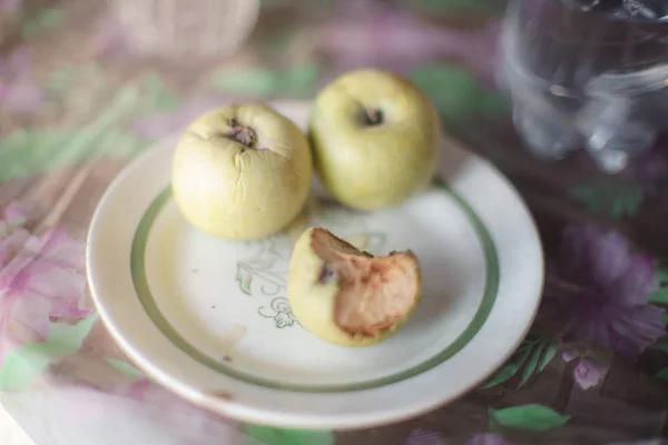 Old apples in a plate