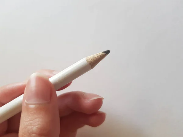 Mano de mujer con lápiz sobre fondo blanco —  Fotos de Stock