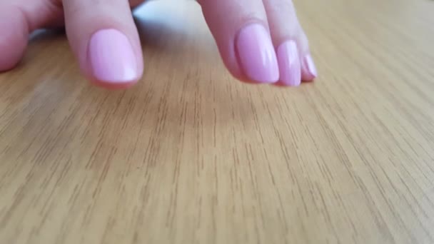 Female Hand White Skin Pink Short Nails Scratching Wooden Table — Stock Video