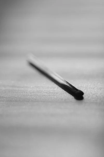 One used match on the table, black and white photo — Stock Photo, Image