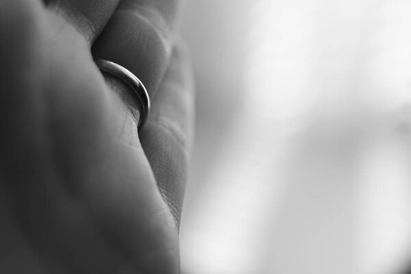young female hand, palm macro photo, ring on the ring finger, bw photo