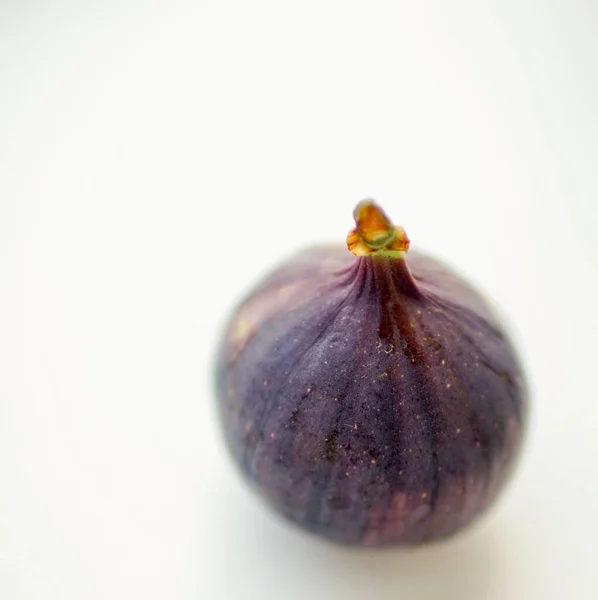 Ripe sweet fig on white blurred table. Selective focus — ストック写真