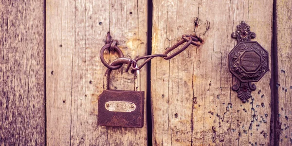 ハンドル チェーンとロック付きの古い木製のドア — ストック写真