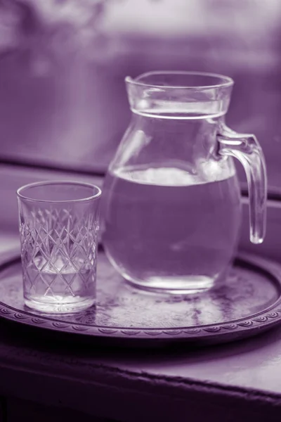 Кувшин Воды Стакан Подоконнике Фиолетовый Тон — стоковое фото