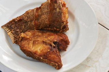 İki adet beyaz tabak kızarmış orfoz balık