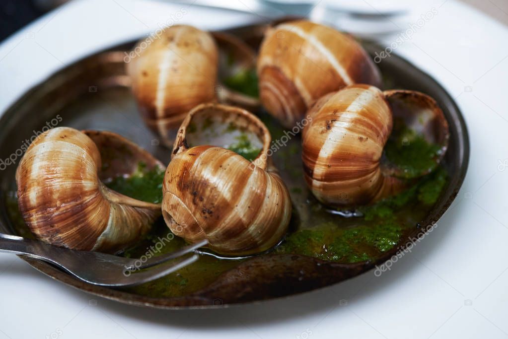Close-up view of baked snails with garlic butter
