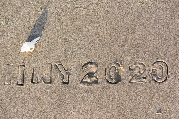 Concept of happy new year 2020 on the beach