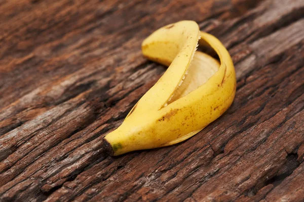 Banana descascada no fundo de madeira — Fotografia de Stock