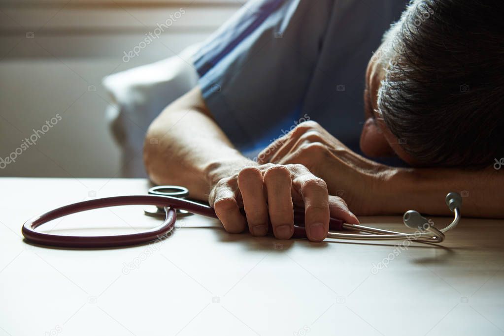 A burnout doctor feeling tired in medical office