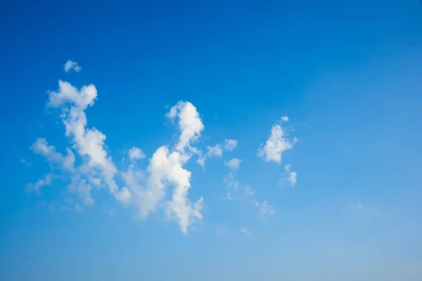 Puffy clouds and blue sky background