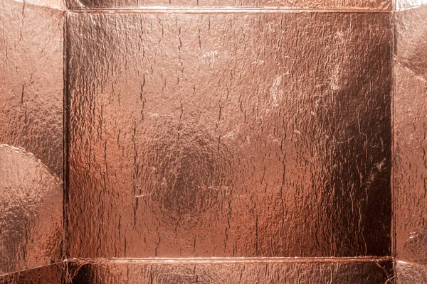 Metallic rose gold foil texture as abstract background.
