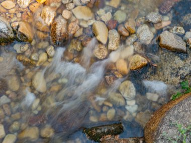 Kayalık dipten akan bir dereden akan su.