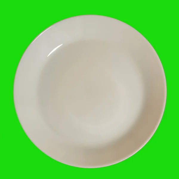 Weißer Teller auf grünem Hintergrund — Stockfoto
