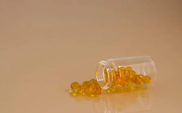 Transparent jar with yellow pills — Stock Photo, Image