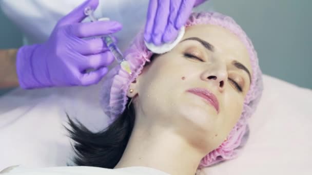 メソセラピーの手順のための美容クリニックで見つける肯定的な女性 首に美しさの注射を得るかわいい女性 — ストック動画