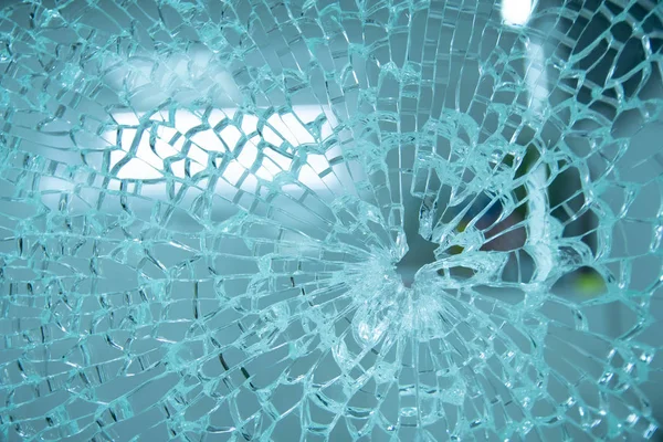 Broken window with a hole in the middle — Stock Photo, Image