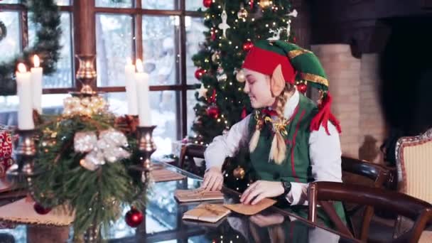 Elf Girl Sits Room Christmas Tree Looks Letters Children Santa — 图库视频影像
