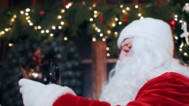 santa claus is trying to read a letter through a magnifying glass