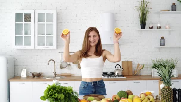 Emotional Girl Plays Slices Orange White Modern Kitchen Fruits Vegetables — Stock Video