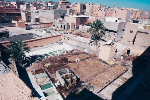 Tanning and dyeing of the skin of a camel and cows in special bathtubs. City block of artisans in Marrakech Morocco. Dye tanks at the leather tannery.