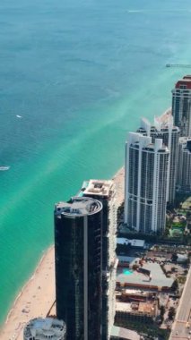 Sunny Isles Sahili Florida. Atlantik Okyanusu Sahili. Güzel deniz manzarası. Deniz suyunun turkuaz rengi. Ada 'daki otellerin ve otellerin hava görüntüsü. Dikey