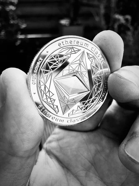 Digital currency physical metal silver ethereum coin. Cryptocurrency money concept.