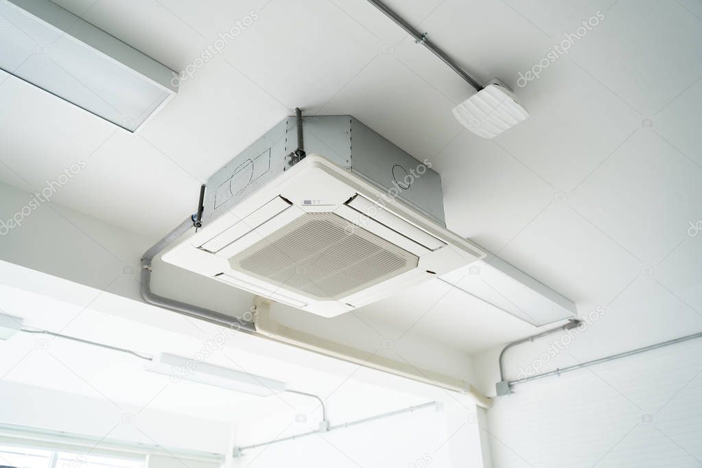 Split type air condition unit hanging on the white ceiling.