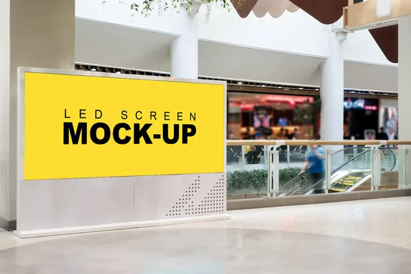 Mock-up blank LED yellow screen billboard near escalator in mall