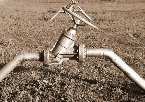 gate valves to close or open the natural gas flow from the storage area to the natural gas distribution network of pipeline  with sepia toned effect