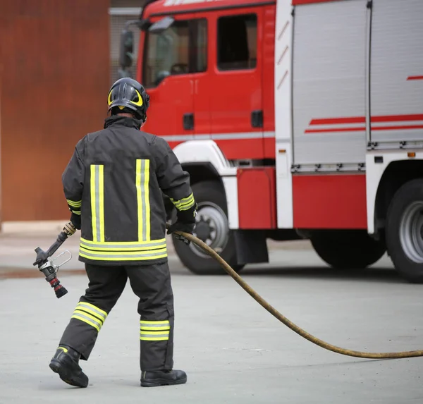 Feuerwehrmann Mit Wasserschlauch Nach Löschen Eines Großbrandes — Stockfoto